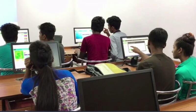 students working in pairs on computers